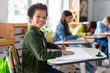 © Home-stock - Smiling black boy writing in classroom, learning, knowledge and study. Latin male pupil at school, preparing for exam test and project