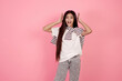 © Ирина Щукина - Young shocked teenage girl on pink background in studio.