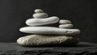 Stone Balancing. Balancing rocks on black background. Stacking. Rocks are piled in balanced stacks
