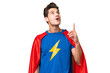 © luismolinero - Super Hero caucasian man over isolated background pointing up and surprised