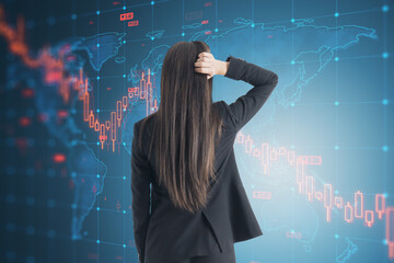 Poster - Back view of young businesswoman in suit looking at falling forex chart and map on blurry blue grid background. Financial crisis, trade and recession concept.