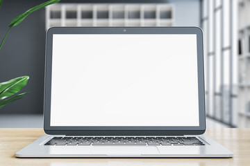 Wall Mural - modern designer office desk with empty white mock up laptop screen and other items on blurry office 