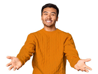 Wall Mural - Young Chinese man in studio background showing a welcome expression.