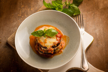 Canvas Print - eggplants parmigiana with basil leaves