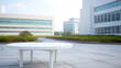 © Megalith - An empty desk table with business office background, modern office table mock up, surrounded by high-rise buildings