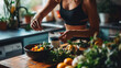 Healthy Meal Prep with Fresh fruits, vegetables and Greens. Focused individual prepares nutritious meal, surrounded by array of fresh greens, avocado and health supplements, in home kitchen