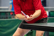 table tennis player serving in a table tennis championship match