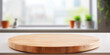 Round wooden table on blurred kitchen background