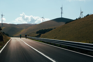 Wall Mural - A wind farm or wind park at sunset located in the mountains of Italy Europe and it allows to realize clean energy. It’s sustainable, renewable energy for enviromental. Nature sky background positive