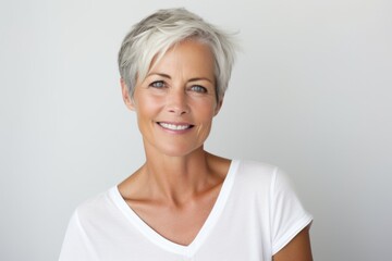 Wall Mural - Portrait of a beautiful middle aged woman smiling at the camera.