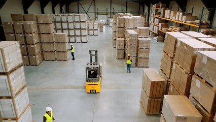 Wall Mural - Top view of full team of warehouse employees walking in warehouse. Team of workers, managers, female director in modern industrial factory, heavy industry, manufactrury.