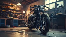 Custom Bobber Motorbike Standing In An Authentic Creative Workshop. Vintage Style Motorcycle Under Warm Lamp Light In A Garage