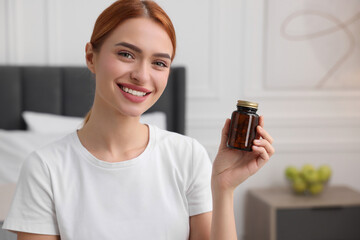 Sticker - Happy young woman with bottle of pills in room, space for text. Weight loss