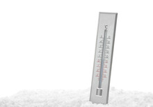 Weather thermometer in snow against white background