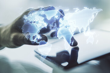 multi exposure of abstract graphic world map and hand working with a digital tablet on background, c