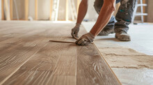 Person Installing Wood Flooring In An Empty Room,a Close Up Of A Man Laying A Wooden Floor On A Hard Wood Floor Depicts A Man Installing Wooden Flooring. Home Renovation, Construction,new Floor Instal