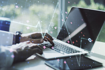 Creative concept of heart pulse illustration and hands typing on laptop on background. Medicine and healthcare concept. Multiexposure