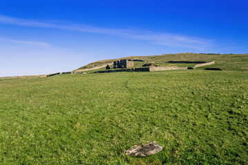 Sticker - Old farm ruins on a meadow with stone walls