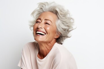 Close up portrait of a happy senior woman laughing isolated on white background