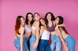 © JoseIMartin - Six smiling women embrace in a show of unity and body positivity, set against a cheerful pink background
