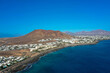 © familie-eisenlohr.de - Playa Blanca coastline. Aerial drone panoramic view with Red volcano in the Background. Tourism and vacation concept. Flamingo beach  Lanzarote, Canary Islands, Spain.