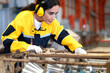 © Nassorn - Latin engineer in safety uniform work in heavy steel engineering factory. Young female hispanic worker wear protective gear checking production machinery equipment in metalwork manufacturing facility