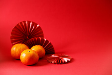 Wall Mural - Chinese new year festival decorations with tangerines and red Chinese folded fans.