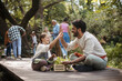© Westend61 - Young man and girl with herb crate highfiving at community garden