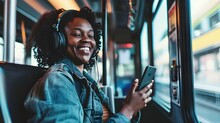 Happy Young African American Woman Passenger Listening Music Via Smart Mobile Phone In A Train, Smile Female Wearing Wireless Headphones While Moving In The Tram