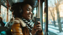Happy Young African American Woman Passenger Listening Music Via Smart Mobile Phone In A Train, Smile Female Wearing Wireless Headphones While Moving In The Tram
