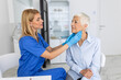 © Graphicroyalty - Friendly woman doctor wearing gloves checking sore throat or thyroid glands, touching neck of senior female patient visiting clinic office. Thyroid cancer prevention concept