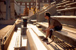 © Flamingo Images - Man with a prosthetic running blade sitting outside on bleachers