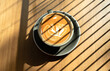 © SandyHappy - A cup of latte and Croffle on wooden table. Late art coffee in a coffee cup top view exposed to sunlight