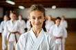 Karate girl, portrait of a girl wearing white kimono, happy and smiling , learning how to fight 