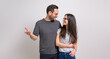 © Moon Safari - Loving couple smiling and holding hands while looking at each other on isolated white background