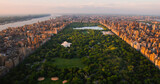 New York Cityscape at Sunset. Aerial Shot from a Helicopter. Modern Skyscraper Buildings Around Central Park in Manhattan Island. Focus on Nature, Trees and Lakes in the Park in the City