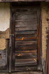 Sunja , Croatia, 05,04,2021: Old wooden rustic door on rural home wall.