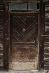 Sunja , Croatia, 05,04,2021: Old wooden rustic door on rural home wall.