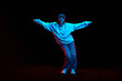 © master1305 - Hip hop culture. Young woman in sportive clothe dancing modern dance styles isolated over black background in neon light. Concept of contemporary dance, street style, youth, hobby, action, lifestyle