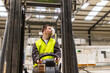 © Halfpoint - Portrait of young man with Down syndrome driving forklift, working in factory, warehouse. Concept of workers with disabilities, support in workplace.