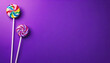 colorful lollipops on violet purple background