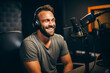 © Рика Тс - Smiling young man talking into microphone during podcast in studio