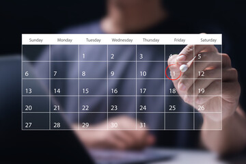 Time management concept. Man use laptop to manage time for effective work. Calendar on the virtual screen interface. Highlight appointment reminders and meeting agenda on the calendar.