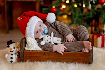  Cute newborn child, baby boy, with mom and dad on Christmas