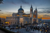 Fototapeta Most - Madrid, Spain 28-12-2022 The Almudena Cathedral during a colorful sunset, it is the most important  and Catholic religious building in Madrid and a visit is free of charge except for the crypt  
