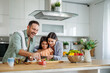 © ivanko80 - Happy family cooking together in kitchen