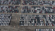 © Red Lemon - Aerial view of a new car lot, neatly arranged vehicles reflecting uniformity and precision, symbolizing organized commerce and transportation.