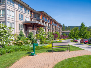 Poster - Walkway along modern apartment building on bright, sunny day