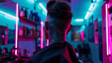 Fototapeta Miasto - A man with tattoos and a stylish haircut in a modern barbershop lit by neon lights