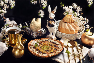 Wall Mural - Easter caramel Mazurek tart and ring cake on black table with white and golden decors